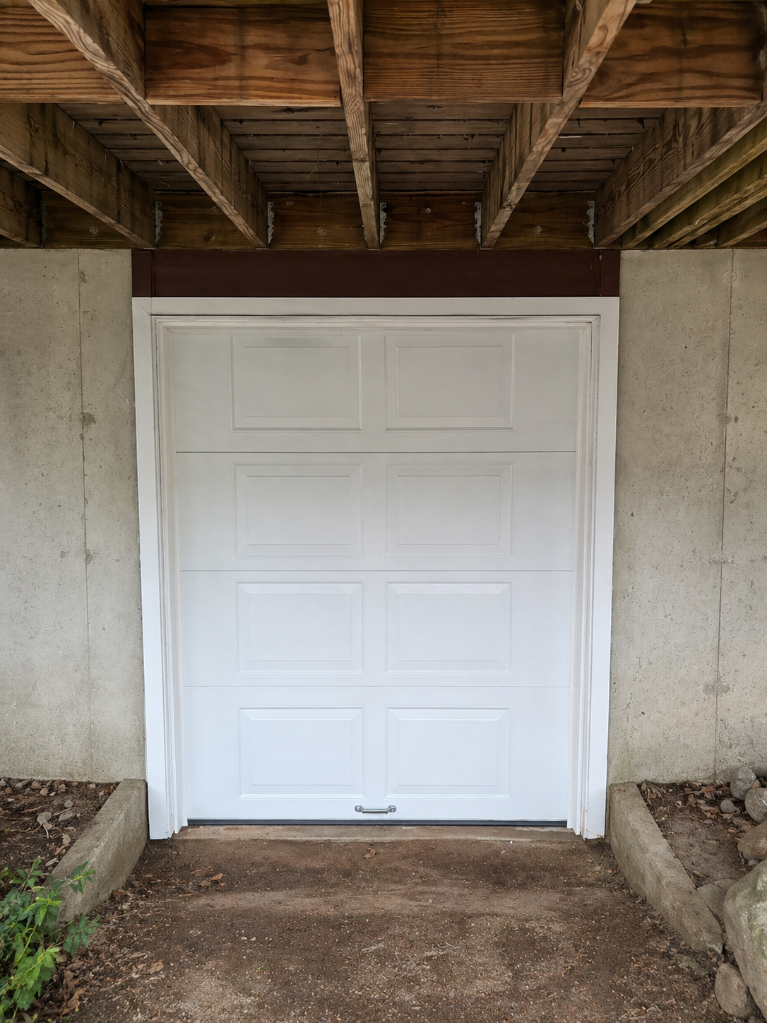 Raised-panel white garage door installation